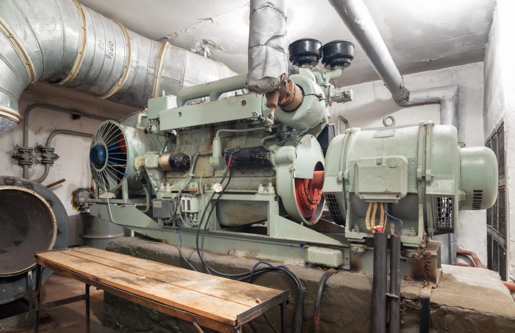 big old diesel generator inside an shelter SBNFJV5